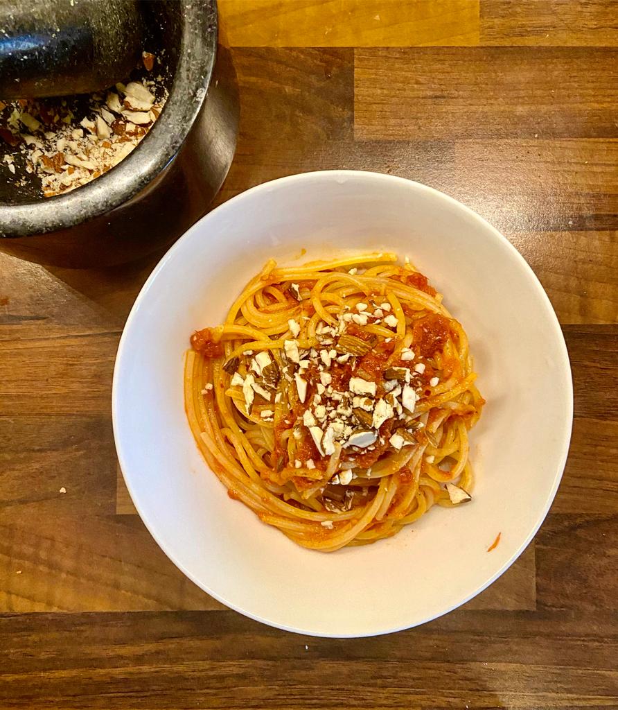 Pasta with red pepper and tomato sauce with crunchy almonds