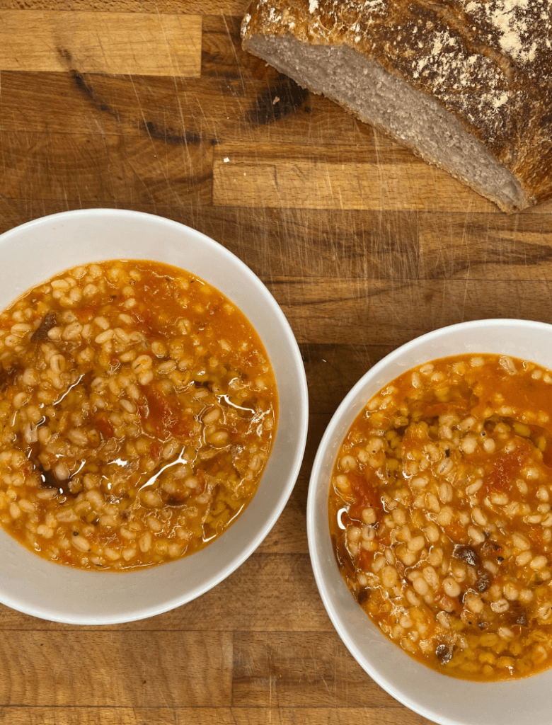 two bowls of barley soup with sourdough bread 