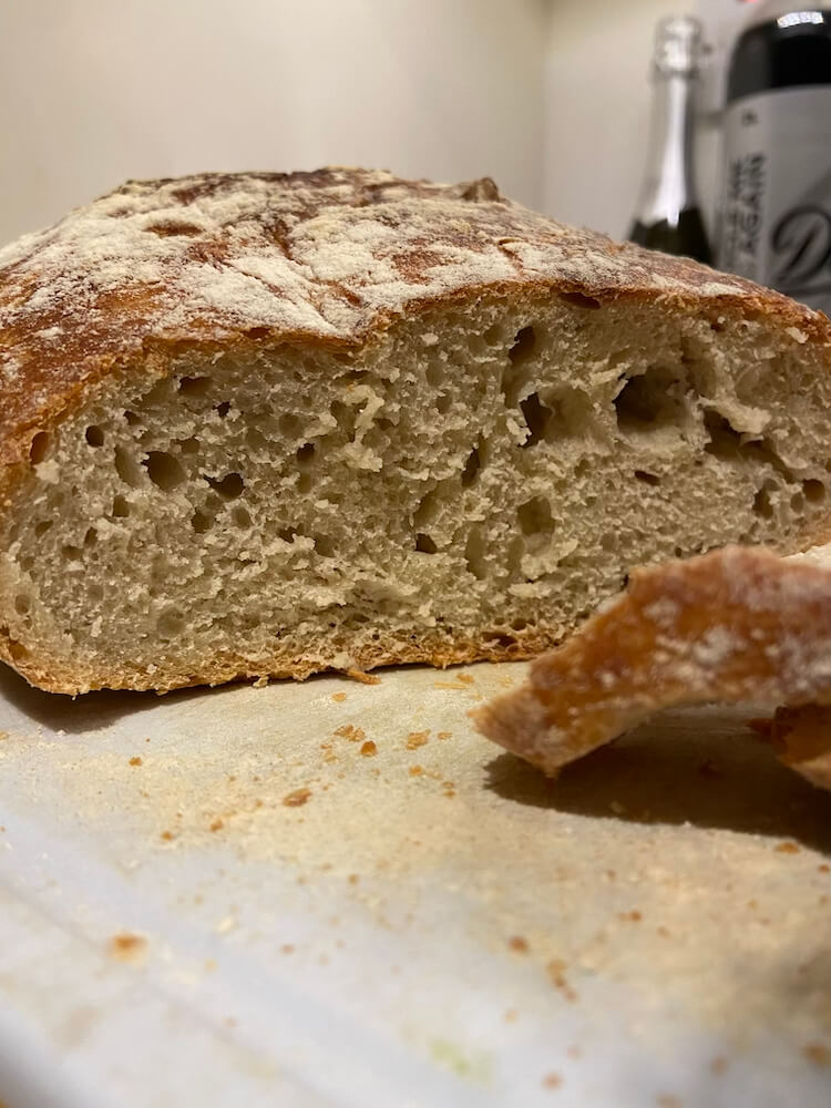 white sourdough bread sliced on cutting board 
