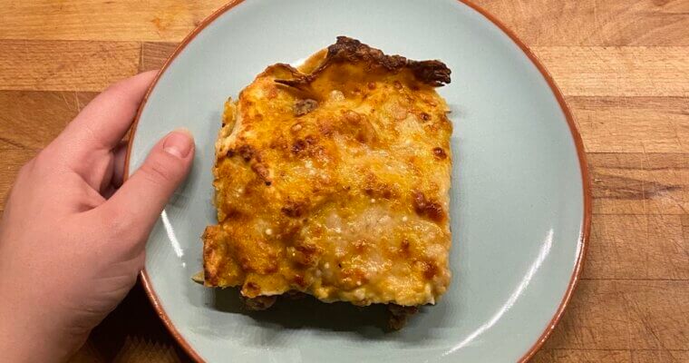 butternut squash and sausage lasagna on blue plate